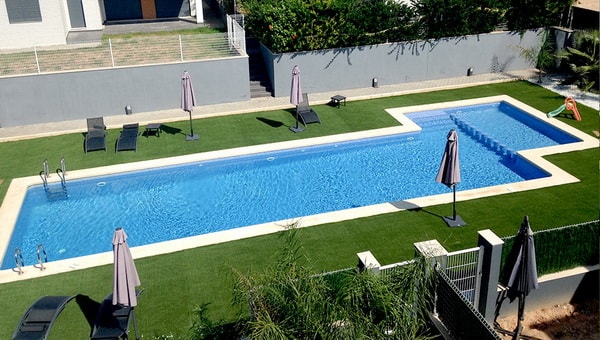 Zona de piscina con césped artificial