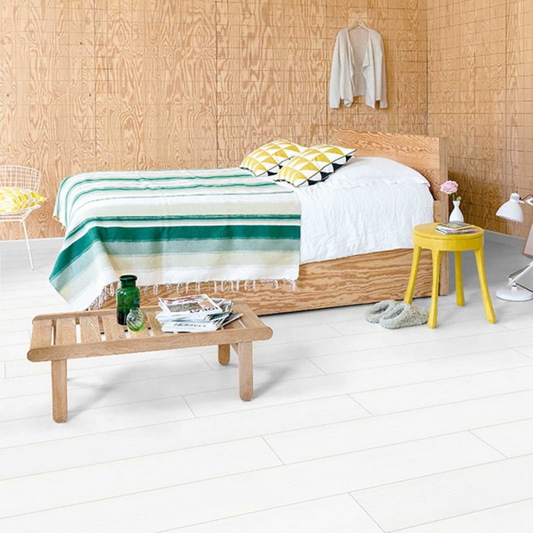 Dormitorio con suelo laminado blanco