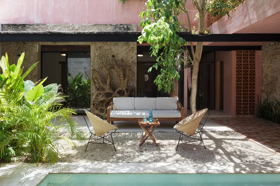 El rosa pigmentado en torno al patio Patio de Casa Luciérnagas con piscina, vegetación y muros de color rosa